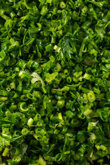 chopped parsley green background texture.