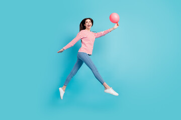 Fototapeta premium Full body profile photo of cool brunette hairdo young lady jump with balloon wear red shirt jeans isolated on blue color background