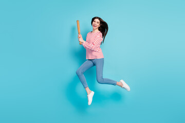 Fototapeta na wymiar Full length body size view of attractive cheery girl jumping having fun fighting bat isolated over bright blue color background