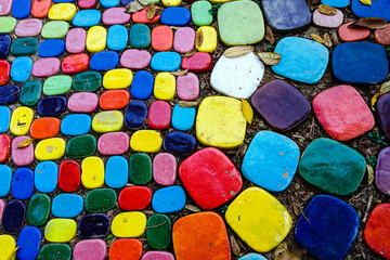 Top view on pieces of multicolored ceramic tiles decorated in garden. Old pavement of tiles textured. Street mosaic cobblestone sidewalk. Abstract,background and pattern of ceramic tile on the floor.