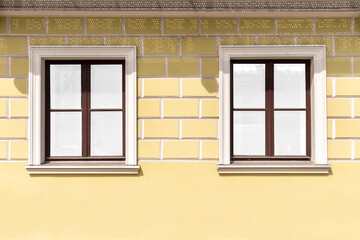 Vintage yellow brick wall and wood window with white glass
