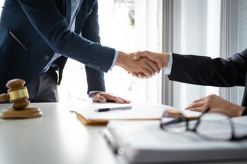 Legal counsel presents to the client a signed contract with gavel and legal law. justice and lawyer concept