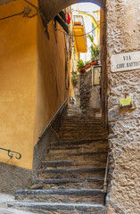 Fototapeta na wymiar Narrow passage with stairs between the old buildings inside the village of Vernazza, Cinque Terre, Italy