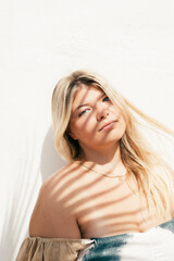 attractive plus size young woman outdoors portrait with tropical shadows