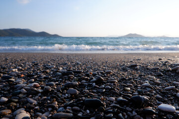 Fototapeta na wymiar beach view with small stones and waves