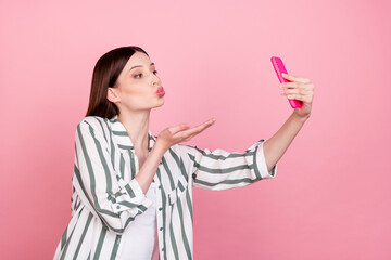 Profile side photo of young girl pouted lips send air kiss video call cellphone isolated over pastel color background