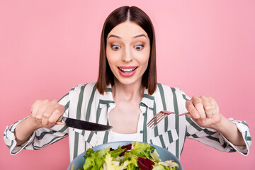 Photo of cool brunette young lady eat tasty salad wear white shirt isolated on pink color background