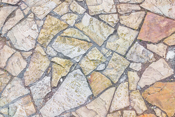 Texture of brown old paving stones flooring mosaic.