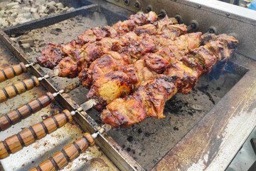 Shish kebabs are grilled on coals on a skewer on the street.