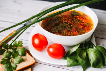 Close up tomato soup with basil leaves. bowl of soup with herbs. Village food	