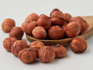 Close-up of hazelnut kernels on a white background, macro-detailed
