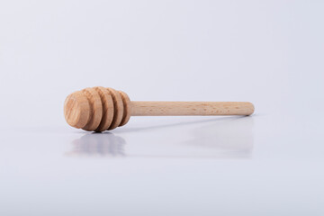 Wooden horse for honey on an isolated white background. Honey spoon. 