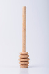 Wooden horse for honey on an isolated white background. Honey spoon. 