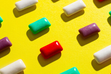Multi-colored chewing gum on a yellow background