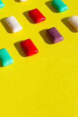 Multi-colored chewing gum on a yellow background
