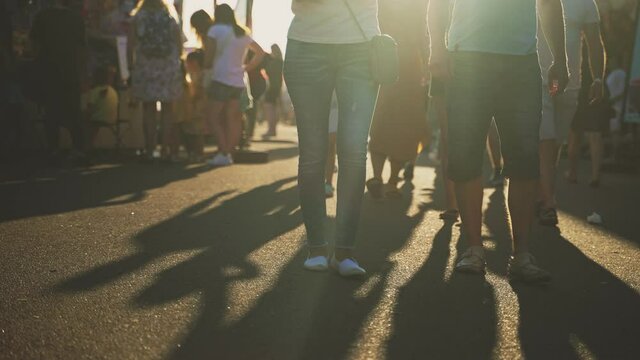 People walk down the street in summer. Blurred shot.