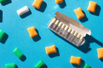 Multi-colored chewing gum on a blue background