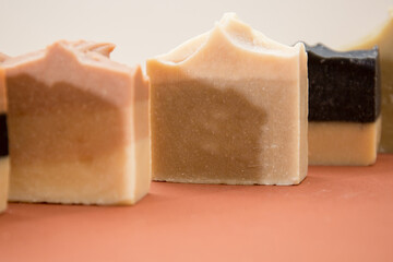 Different hand made soap bars isolated on brown 