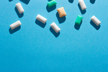 Multi-colored chewing gum on a blue background