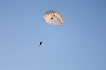 Paratrooper is flying in the sky.