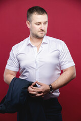 Caucasian mature male businessman in suit with jacket and white shirt taken off. Studio portrait. Looking away