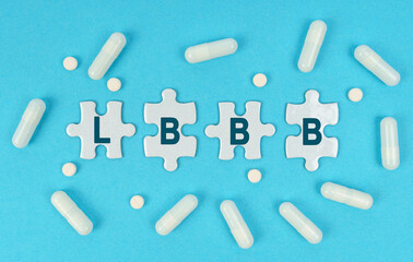 On a blue background, there are pills and puzzles with the inscription - LBBB