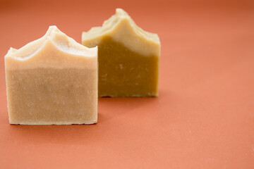 Different hand made soap bars isolated on brown 
