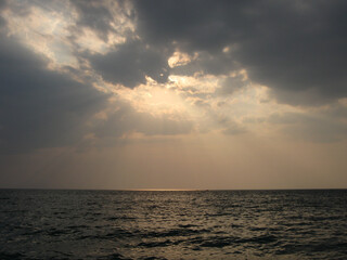 The sea coast at sunset. Sandy beach. A good place to relax with the whole family.