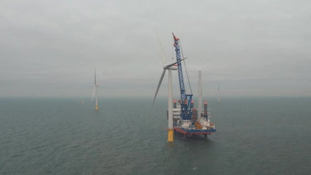 Balmedy, Aberdeenshire, Scotland, UK. Aerial view of a special vessel for the installation of wind farms, installing a wind turbine off the coast of Aberdeen.