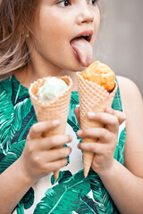 Cute kid girl eating ice cream cone