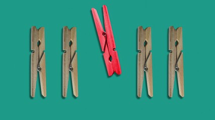 3d illustration - Clothes pegs and one different on color background