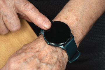 Smart watch black screen - add your graphics on elderly senior hand, closeup detail