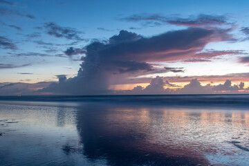 Fototapeta na wymiar Beautiful sunrise at the beach with pretty clouds and blue sky