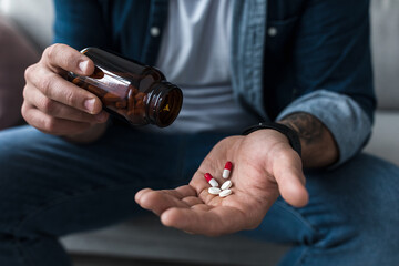 Handful of white pills in male patients palm. Healthcare, treatment, drugs and depression, pain and suicide - obrazy, fototapety, plakaty