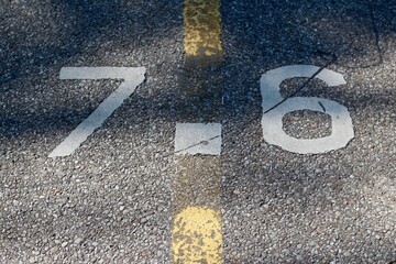 A close view of the mile marker painted on the path.