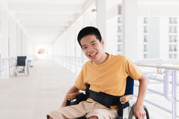 Obraz premium Asian special child on wheelchair is smiling face as happiness on ramp for disabled people background in hospital, Lifestyle in the education age of disabled children, Happy disability kid concept.