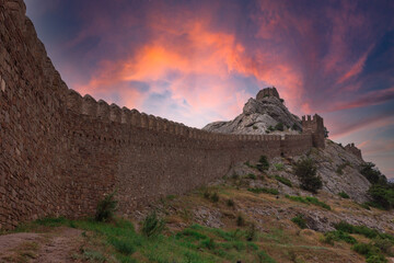 The observation tower of the fortress. A medieval fortress. View of the old stone fortress. The fortress wall.