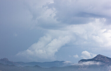 Mountains in the clouds. View of the mountains in the fog.