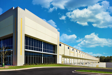 Fototapeta na wymiar Large generic white industrial storage warehouse façade