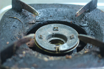 partial focus on old gas stove head, no fire and rusty.