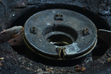 partial focus on old gas stove head, no fire and rusty.