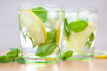 Two glasses of fresh lemonade drink or mojito cocktail