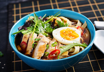 Miso soup. Japanese ramen soup with chicken, egg, nori and  nipposinica on dark background.