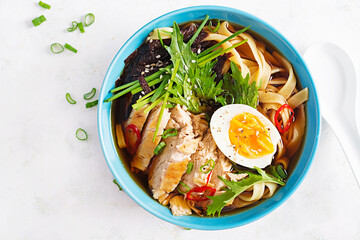 Miso soup. Japanese ramen soup with chicken, egg, nori and nipposinica on light background. Top view, flat lay
