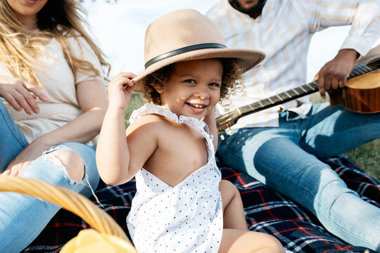 Happy multiethnic family having picnic in nature