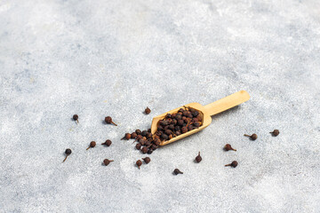 Cubeb pepper in a small bowls and spoon.