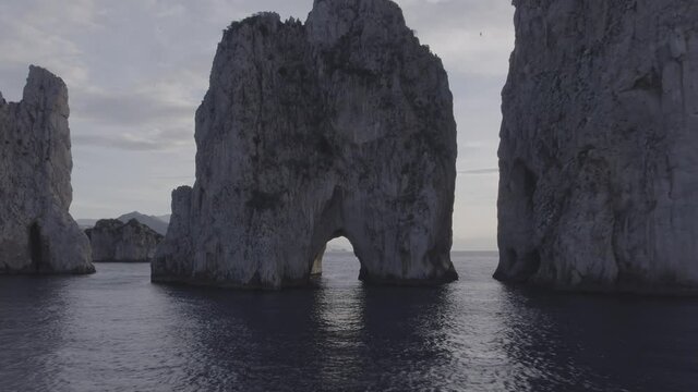 Aerial Drone footage view of Faraglioni Rocks in Sea in Capri Naples Costiera Amalfitana Italy Europe // no video editing
