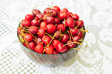 Close up macro view of plate with red ripe cherry isolated.