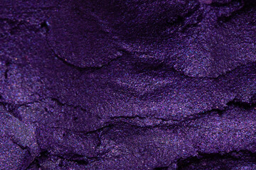 Fototapeta na wymiar Violet lipstick texture close up. Crashed eyeshadow.