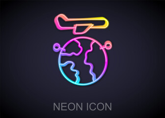 Glowing neon line Globe with flying plane icon isolated on black background. Airplane fly around the planet earth. Aircraft world icon. Vector